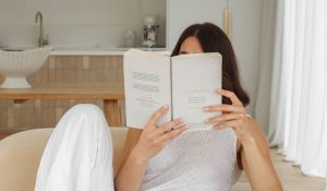 college students holds book while learning about the Millionaire Morning Routine as a Student